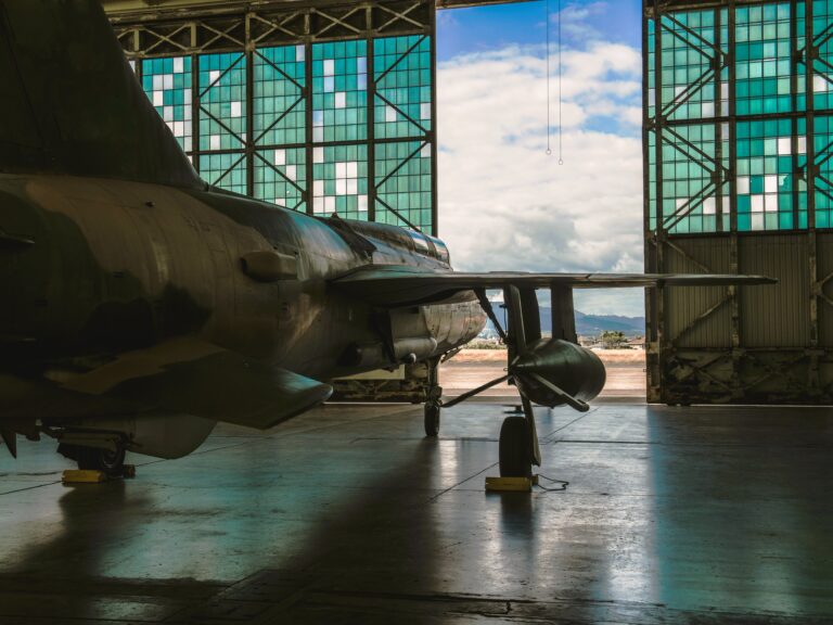 us military jet plane in hangar with hangar doors opening