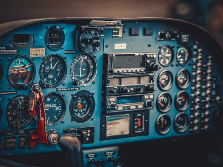 blue teal avionics system in smaller plane with keys and red key chain in view