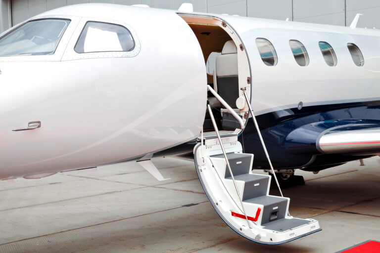 private jet with door open and stairs out for boarding