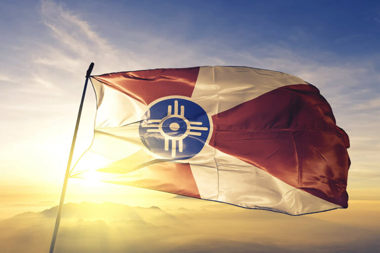 Wichita flag against the sun.